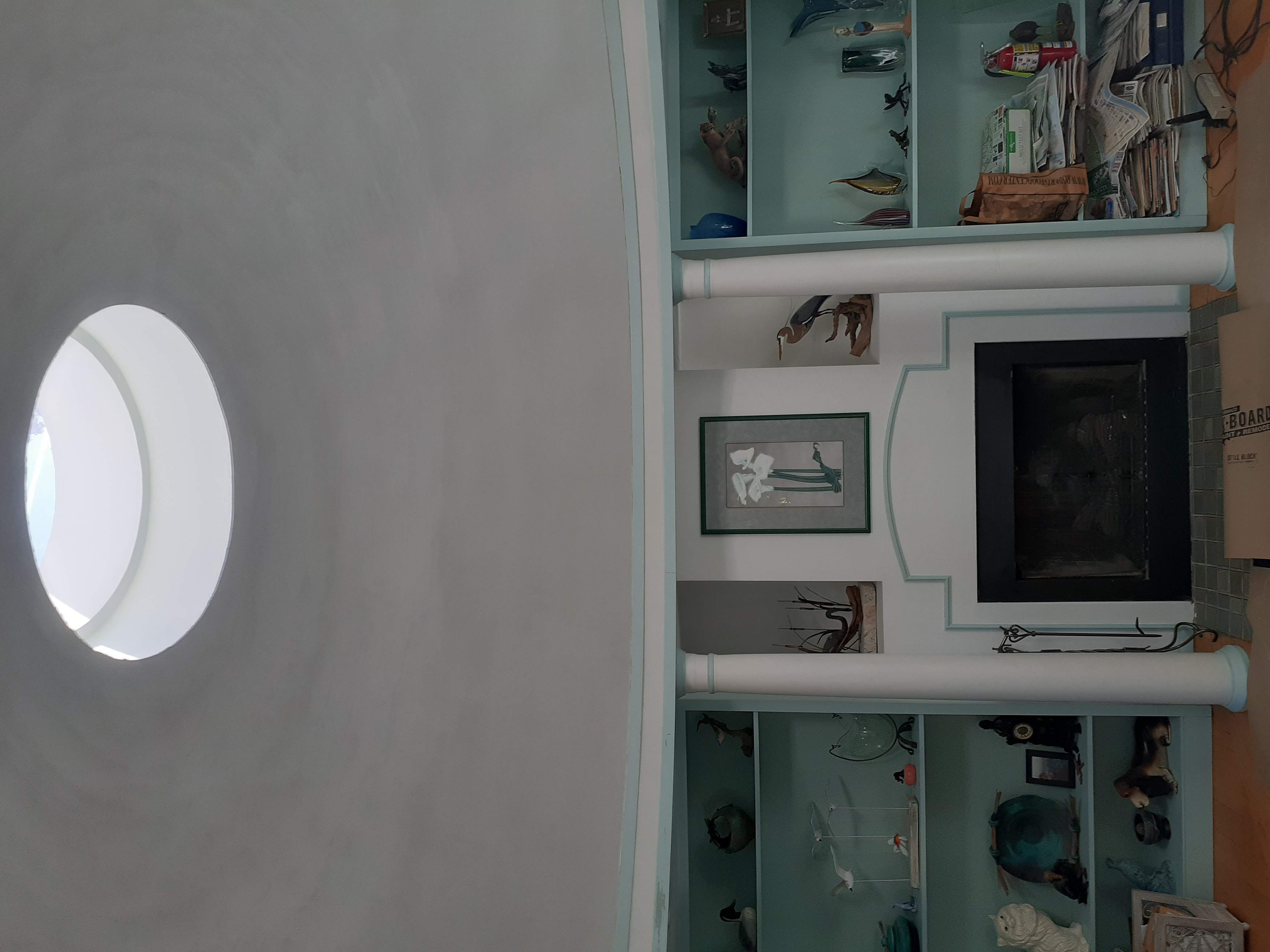 Gray plaster room with oval window