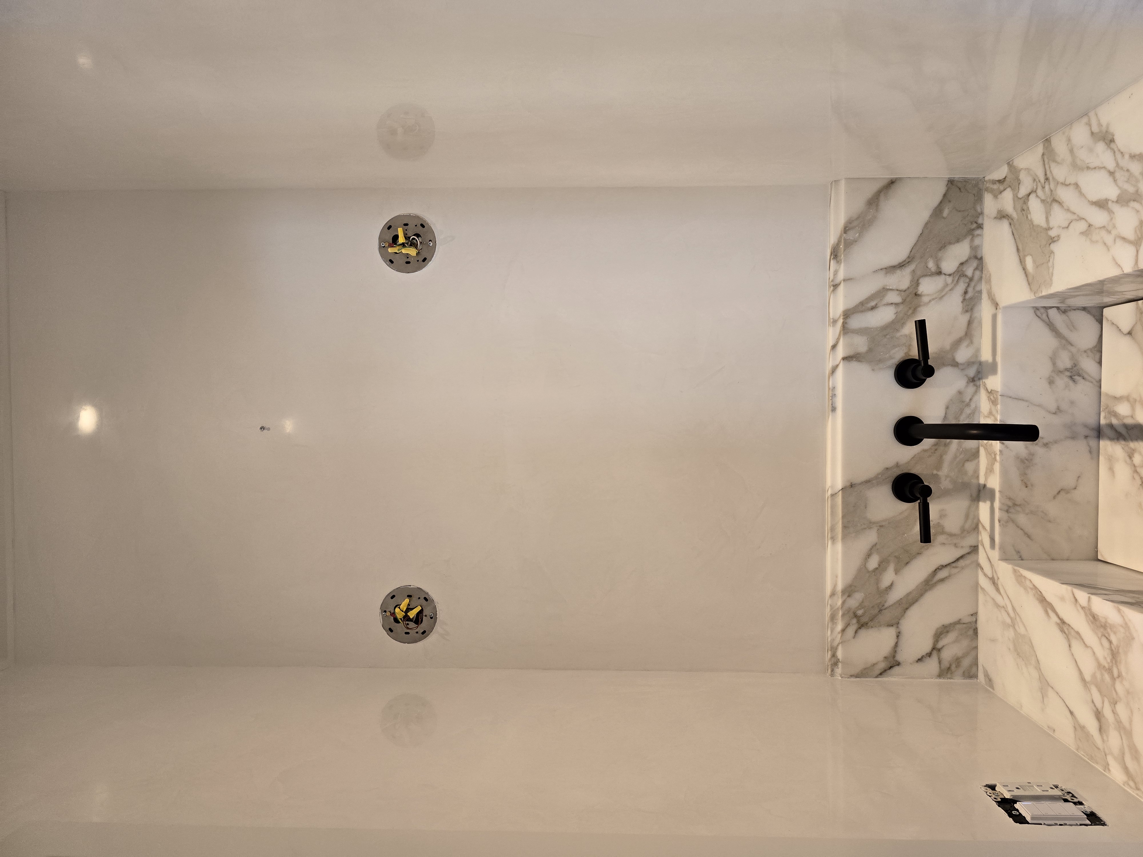 Microcement bathroom with calacatta marble